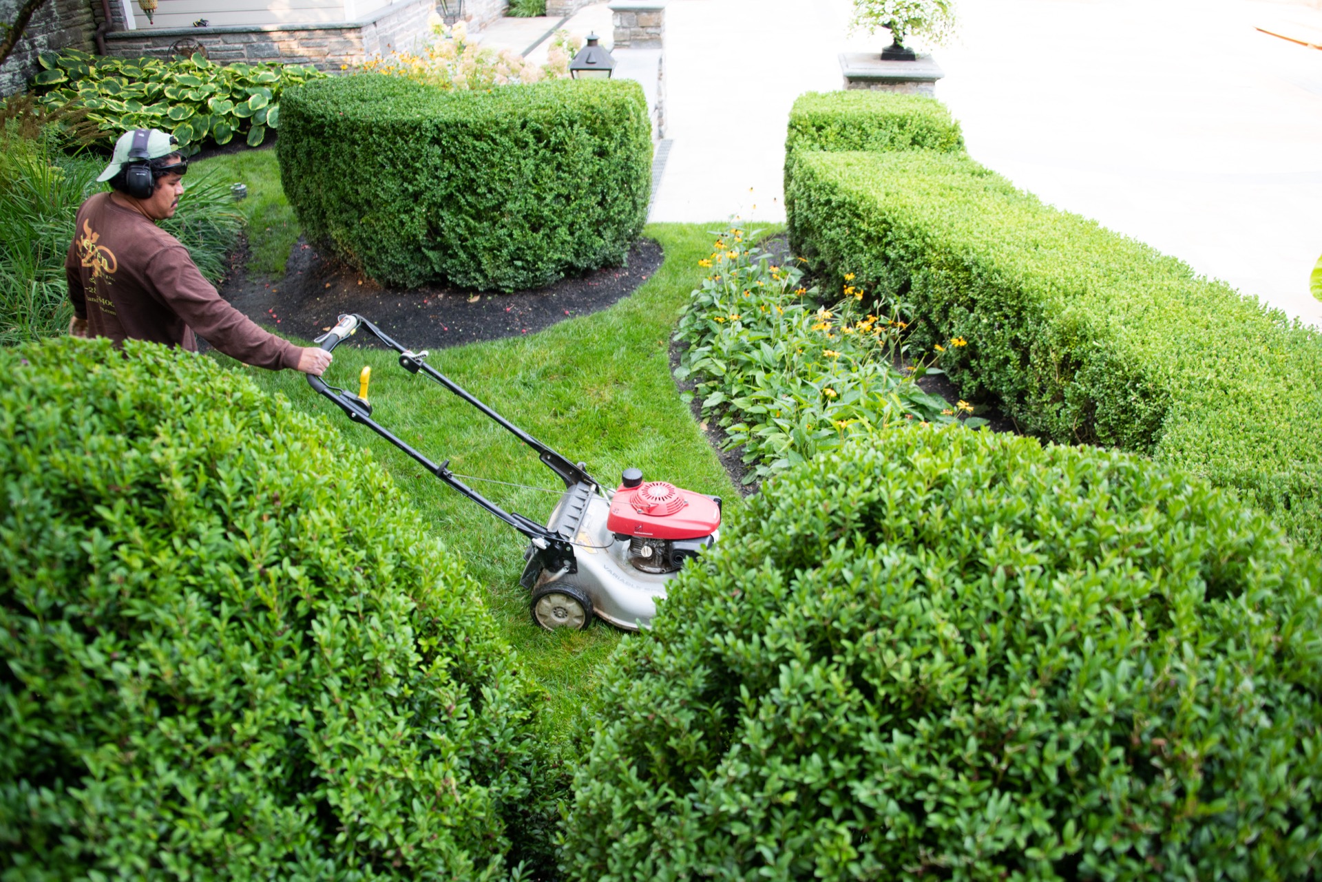 Landscape Laborer Mowing Lawn In Bryn Mawr PA