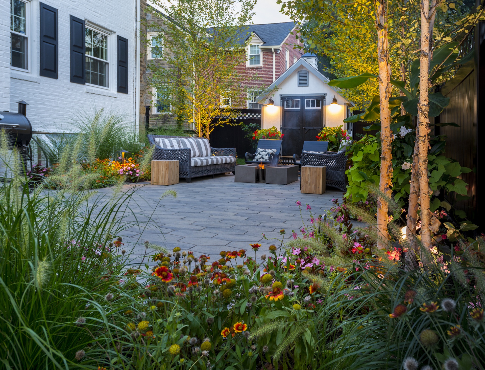 Outdoor Living Space Design In Wynnewood Backyard Patio With Fire Pit And Flowers In Wynnewood PA